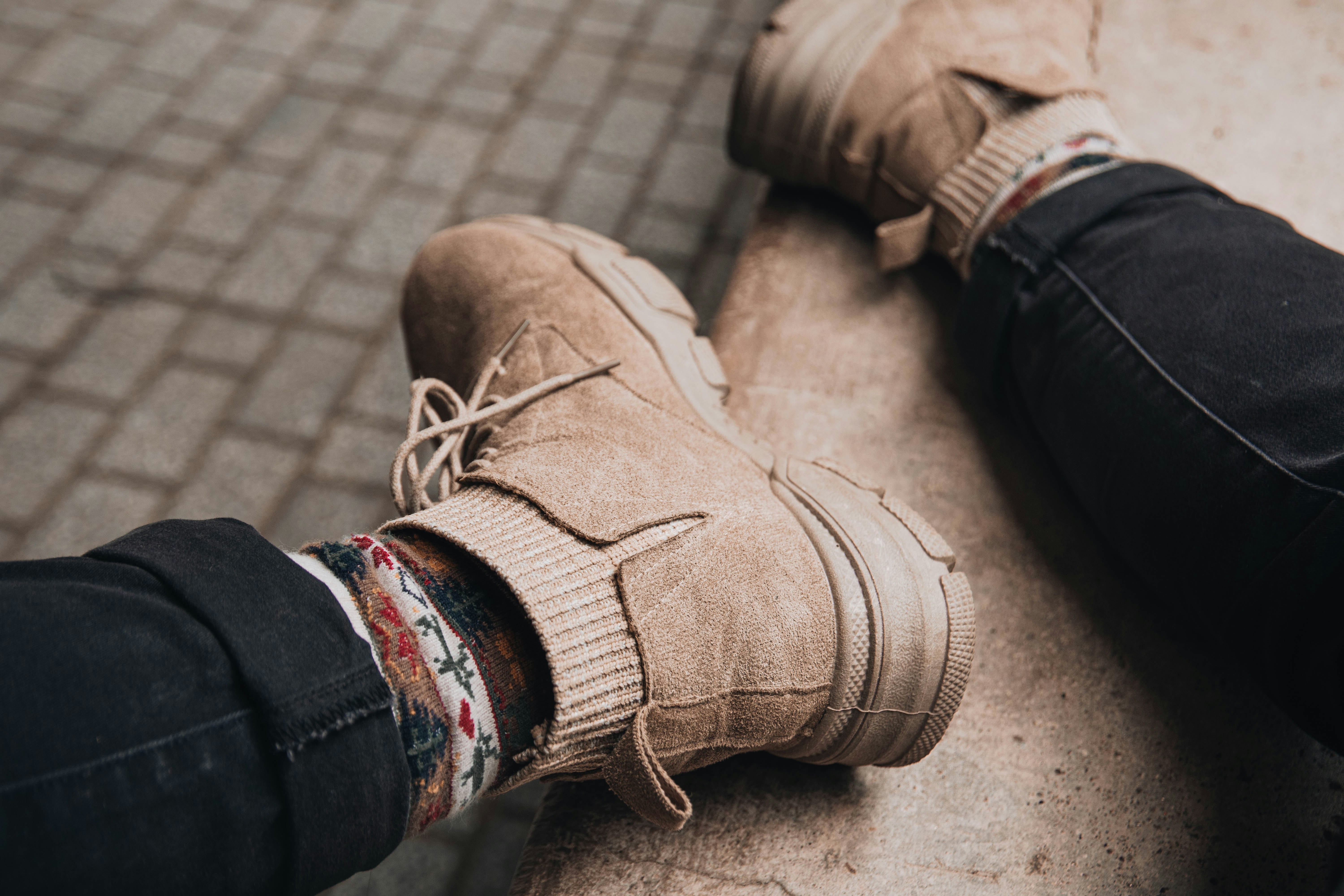 person wearing brown leather boots